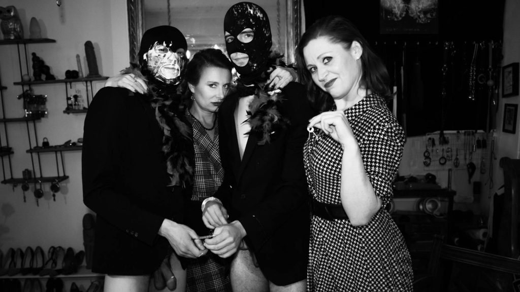 Dominatrices Madame Lule and Inanna Justice with two butt-lers. Enter the backstage BDSM photo gallery.